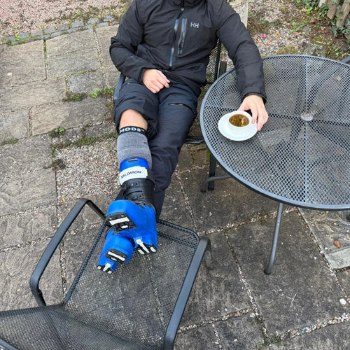 MODS ski shin protector worn with ski equipment, providing targeted cushioning between the shin and ski boot to help minimise pressure and discomfort while skiing.